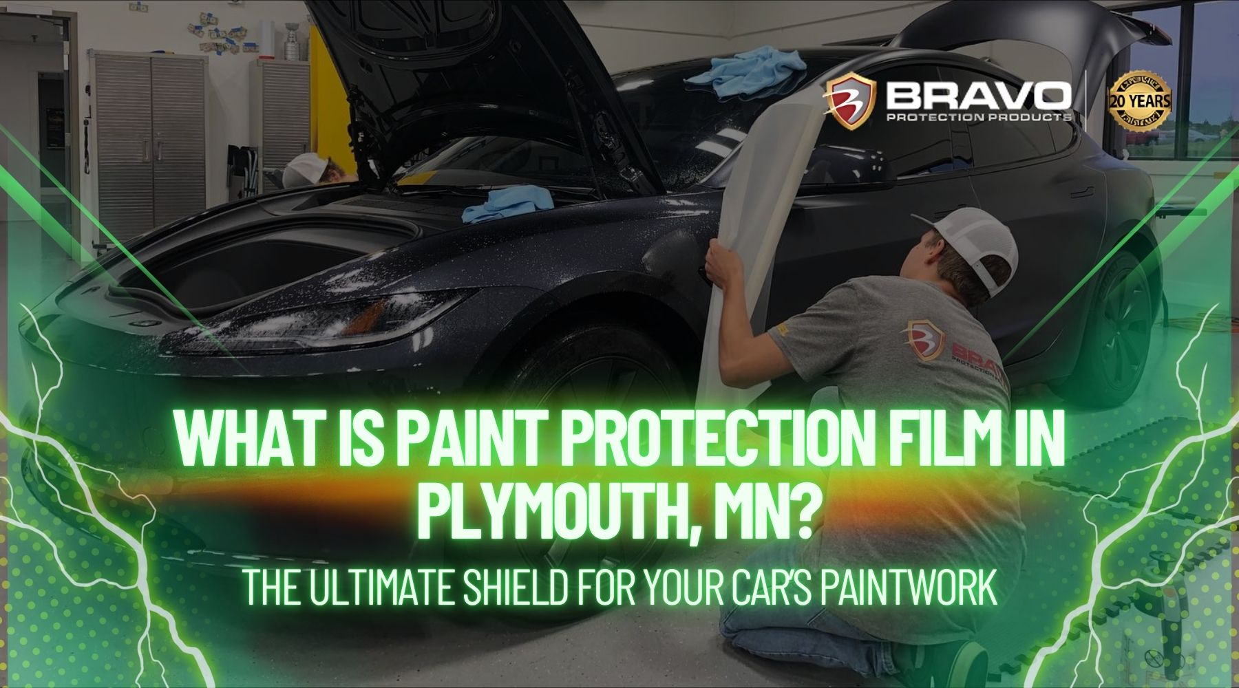 A technician applies paint protection film to the front fender of a black sports car inside a garage. Text over the image reads, “What is paint protection film in Plymouth, MN? The ultimate shield for your car’s paintwork,” with the Bravo Protection Products logo displayed.